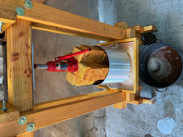 image of apple juice being pressed with a car jack